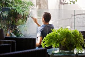 Man in Grey Shirt Cleaning Windows